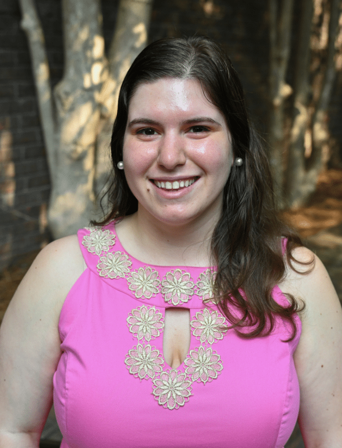 headshot of a woman posing in front of elevated landscaping